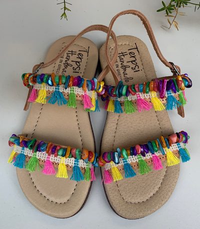 Παιδικά δερμάτινα σανδάλια , ελληνικής κατασκευής από υψηλής ποιότητας δέρμα , διακοσμημένα με πολύχρωμα φουντάκια και πολύχρωμες πέτρες φίλντισι .